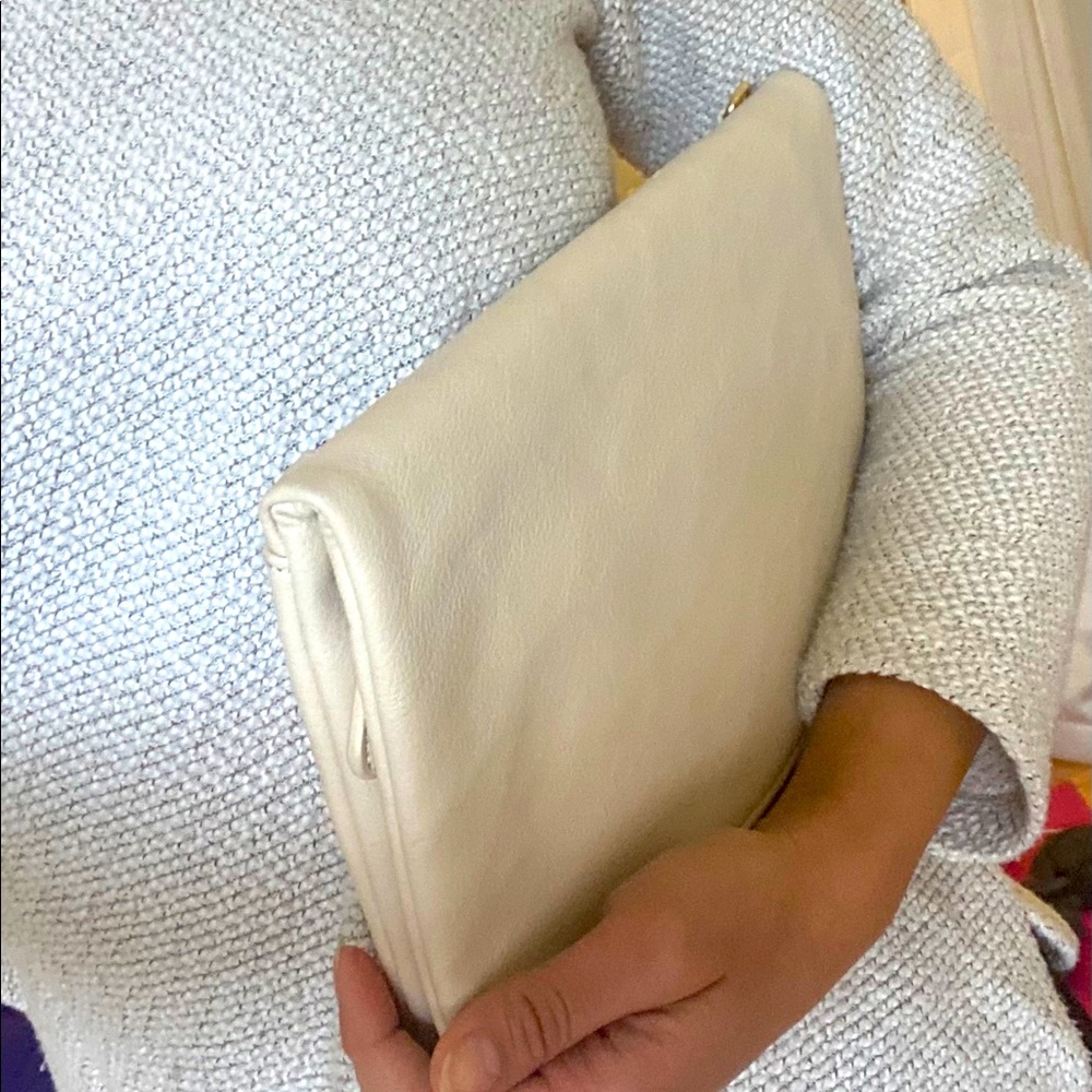 Nude clutch with long strap.
